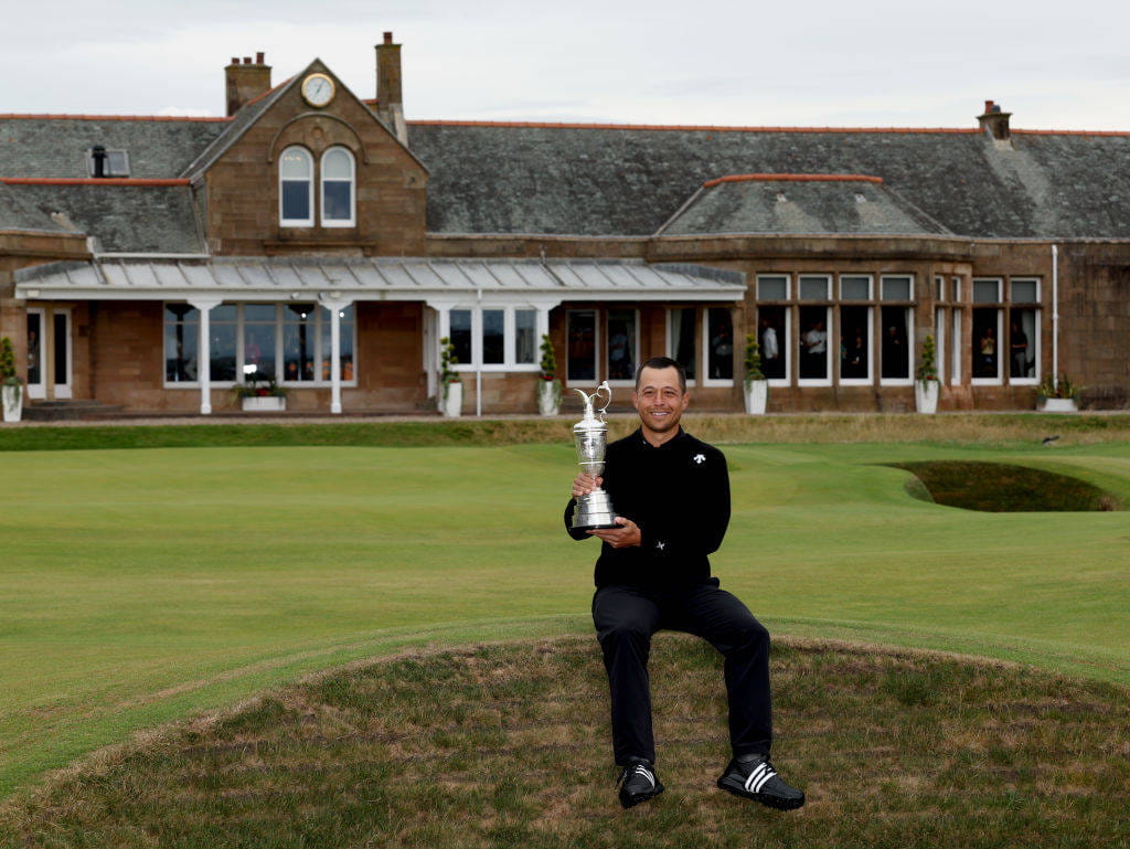 Xander Schauffele sits on a bunker